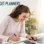 Young woman planning her budget at a desk with laptop, notebook, and coffee, using finance apps to manage money – practical money tips for women 2026